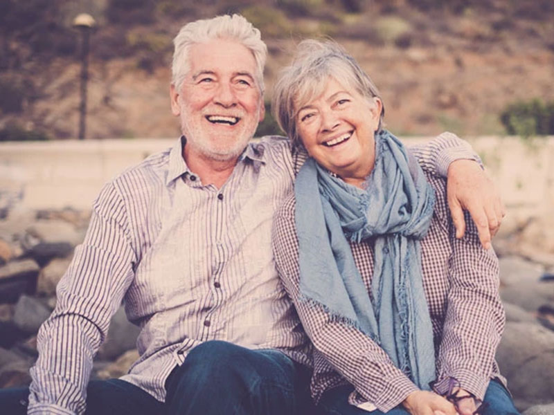 A Old couple sitting together and smiling