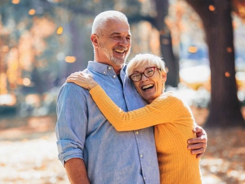 a old couple hugging and smiling