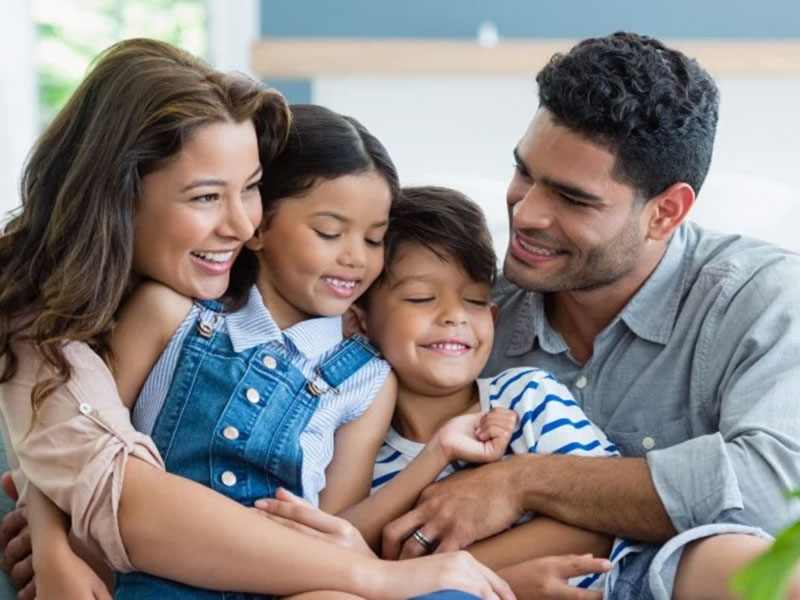 A happy family enjoying quality time together on a couch.