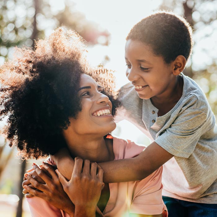 mother and young son smiling